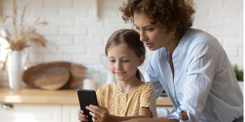 Mother and daughter looking at phone